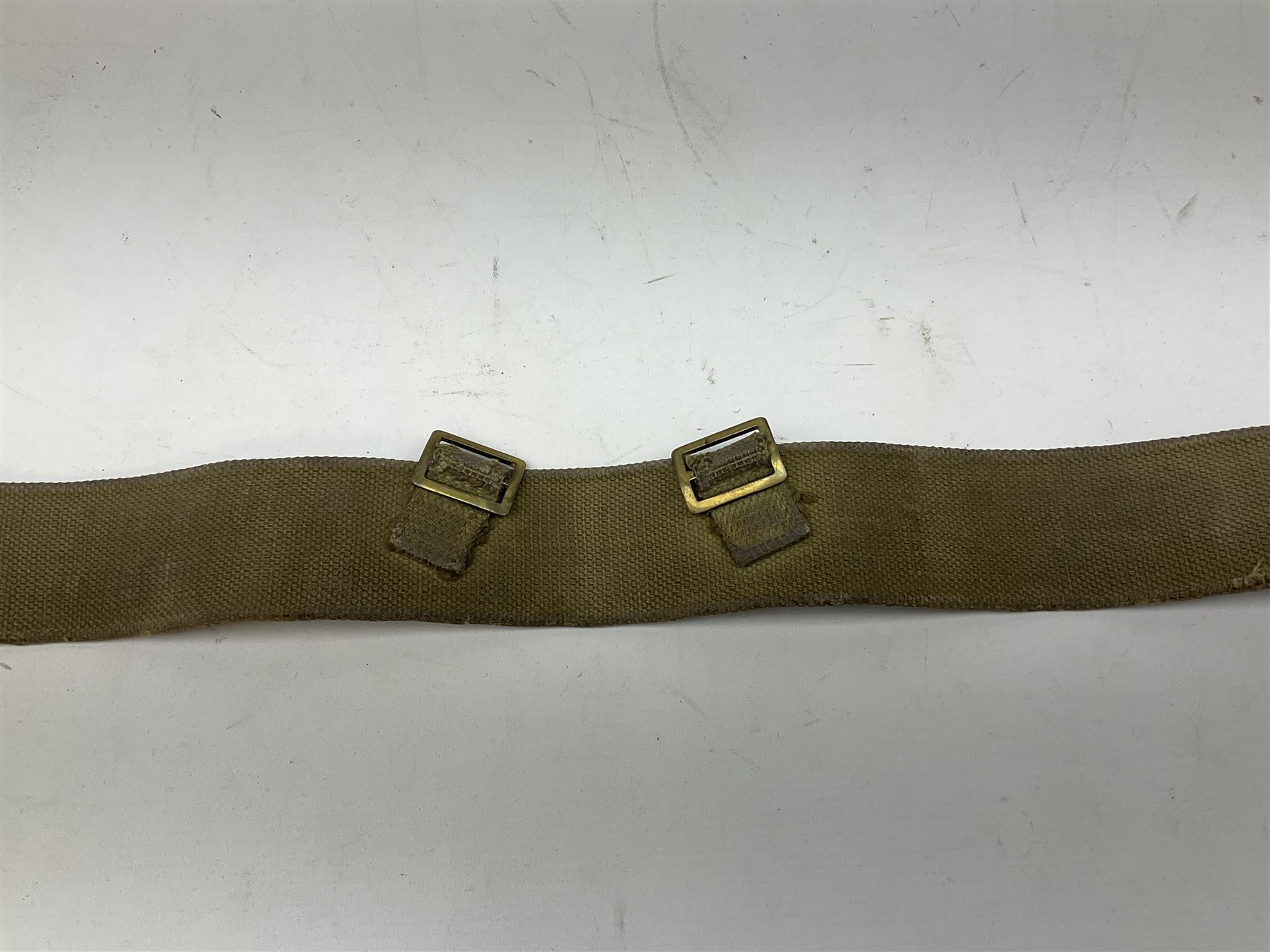 WW2 British black felt beret with Pioneer Corps cap badge, with Kangol Wear maker's mark dated 1943; and a British Army green webbing belt (2)