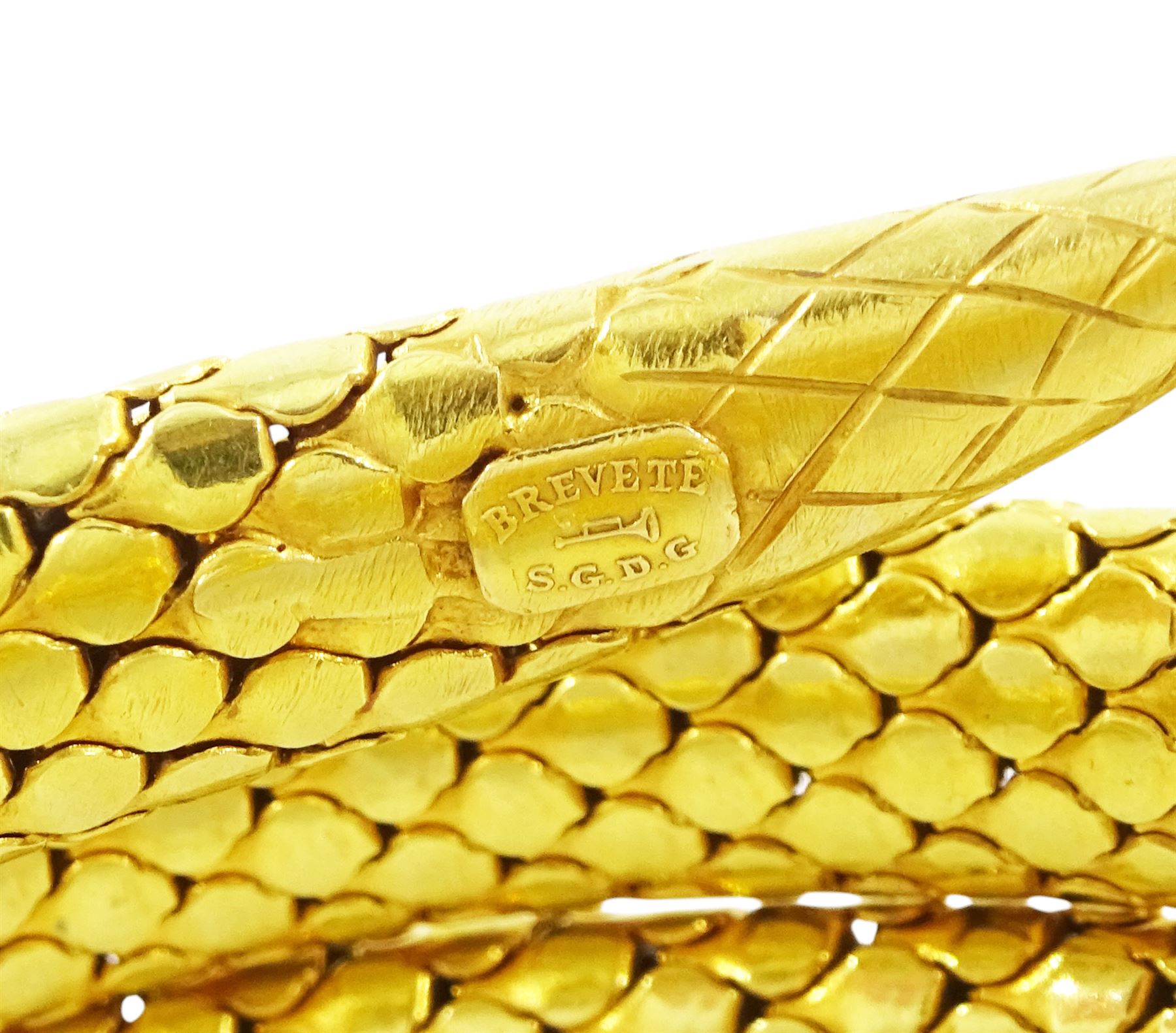 18ct gold coiled diamond snake bangle, the head set with round cut diamonds and emerald eyes, to an expanding articulated body, stamped Brevete S.G.D.G.