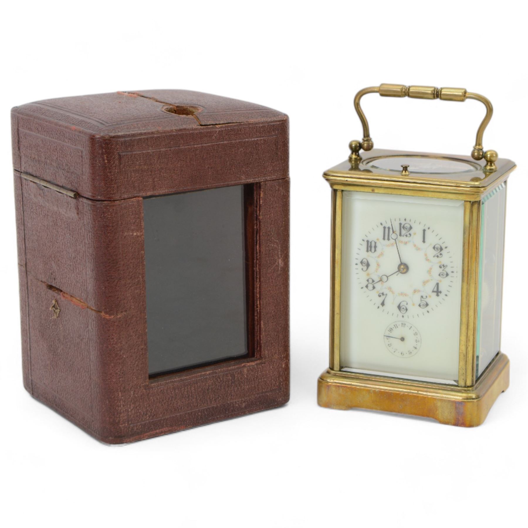 French - Early Edwardian corniche cased 8-day carriage clock, decorative enamel dial with floral garlands, Arabic numerals, minute markers, steel moon hands and conforming alarm setting dial, four rectangular glass panels and an oval viewing glass to the top, with a silvered lever platform escapement and 
timing screws to the jewelled balance, twin train rack striking movement with repeat, sounding the hours, half hours and alarm on a coiled gong.  Original traveling case with viewing glass and key.