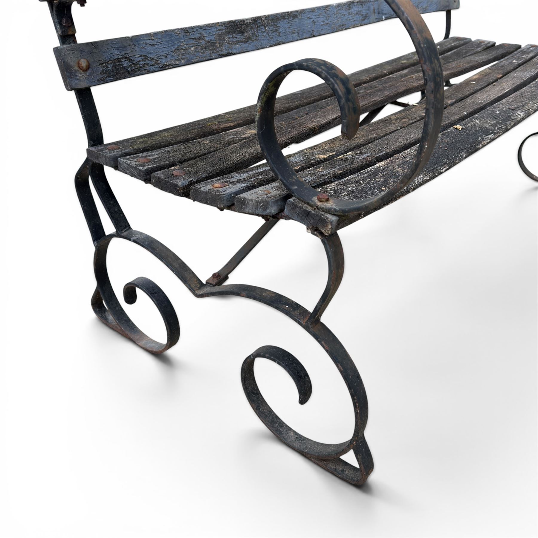 19th century wrought iron strapwork and slatted wood garden bench, the arm terminals and end supports of scrolling form