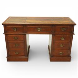 Late Victorian oak nine drawer desk, the rectangular top inset with a tooled leather writi...