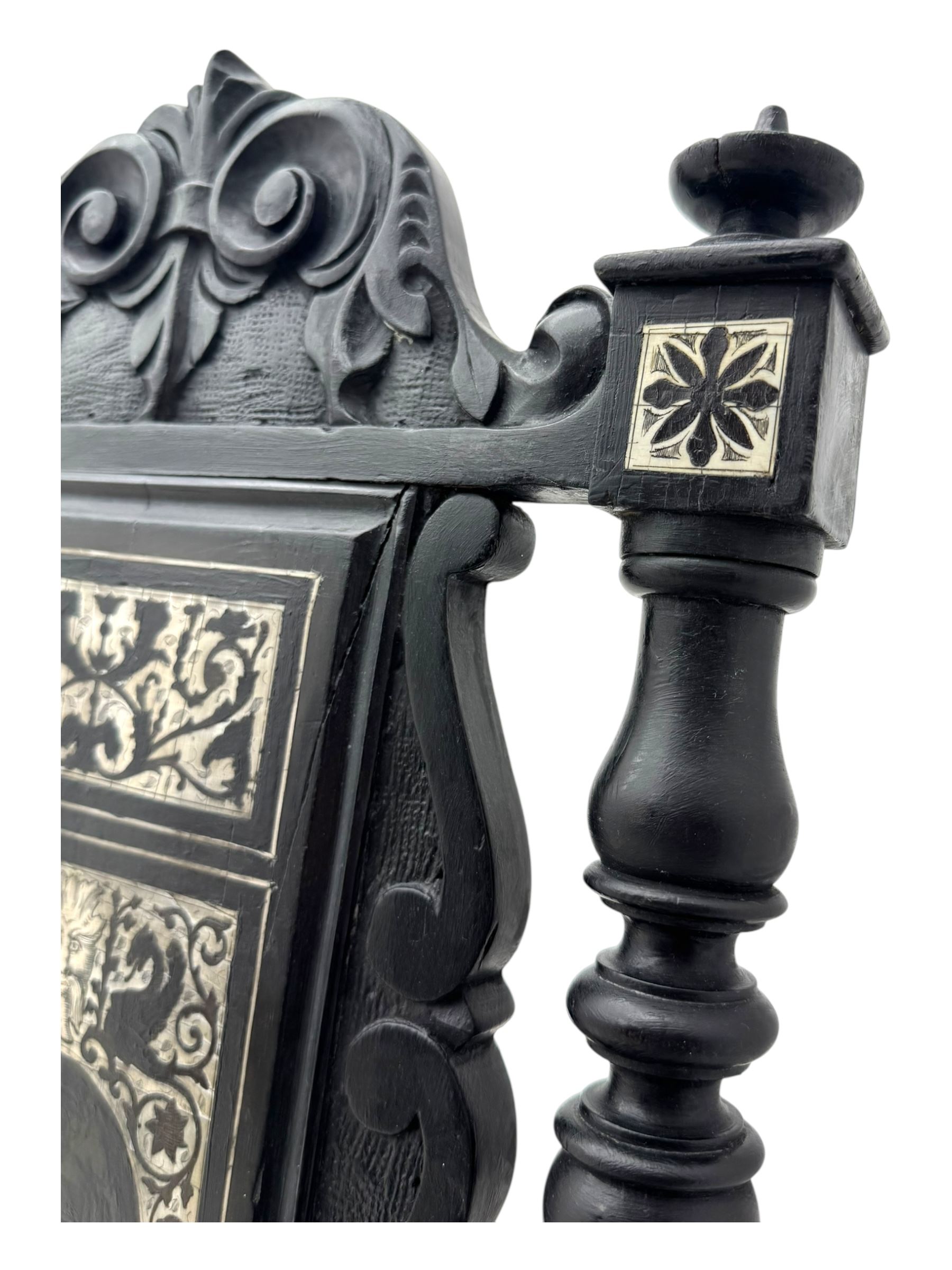 19th century Italian ebonised side chair, the backrest inlaid with bone and decorated with a painted figure in Renaissance dress within an arched reserve, flanked by turned supports and scrolled cresting, the seat and frieze similarly inlaid, raised on turned legs with shaped stretchers