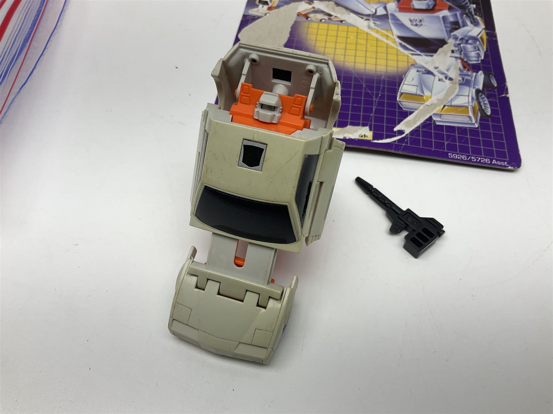 Four 1980sTransformer G1 - Optimus Prime 1984; DinoBot Sludge (Diplodocus) 1984; Cyclonus 1986; and Runamuck 1986; with paperwork; seven Bandai Robo Machines Robots/Transformers; almost fully stocked Panini Sticker album; two annuals; three comics; two posters; and Ladybird story book