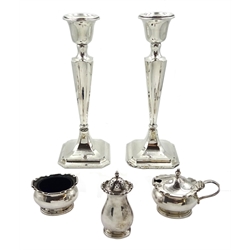 Silver three piece cruet set by Zachariah Barraclough & Sons, Chester 1926 and pair of silver weighted candlesticks Birmingham 1938