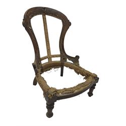 Late Victorian walnut and beech framed nursing chair, with carved scroll decoration, on turned supports 