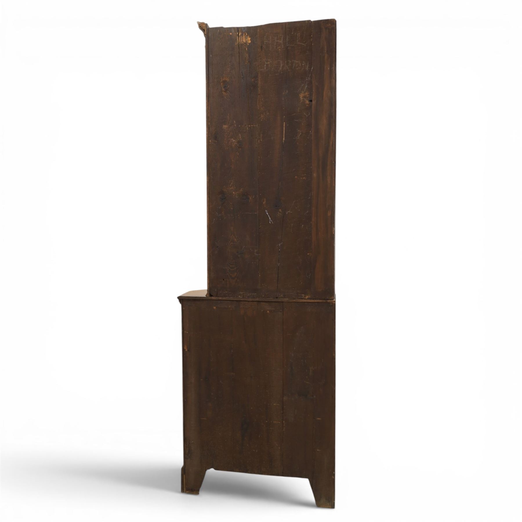 19th century oak floor-standing corner display cabinet, dentil cornice above astragal glass, shaped fixed shelves, the lower section with twin cupboard doors, on shaped bracket feet
