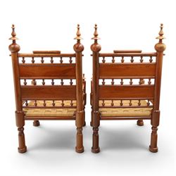 Pair of Anglo-Indian brass inlaid hardwood low chairs, the backs with turned spindle rails and rectangular panels inlaid with scrolling foliate decoration, woven rush seats within moulded frames, raised on turned supports with ring turned feet