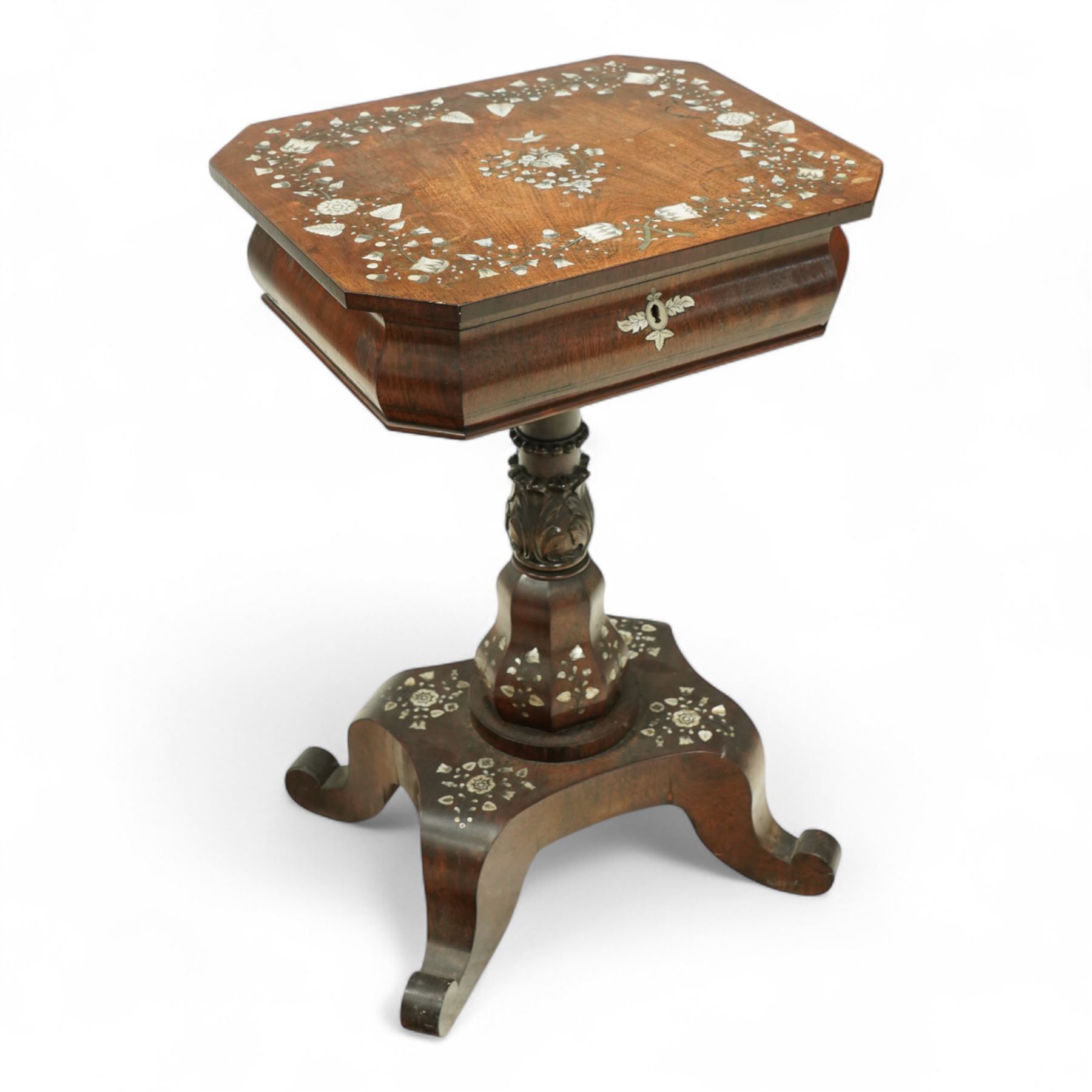 Victorian Mother-of-pearl inlaid rosewood work table, octagonal top inlaid with silvered brass and mother-of-pearl trailing branches of acorn, leaf, and flowering bud decoration, bombe shaped apron with mother-of-pearl leaf inlaid escutcheon, hinged lid with folding mirror, and interior with six lidded compartments and hinged pin cushion above acanthus carved and inlaid pedestal on quattro form base with scroll legs