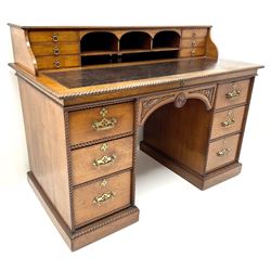Victorian aesthetic oak movement desk, raised back with six drawers above inset leather writing pad, rope twist detailing, six drawers, plinth base
