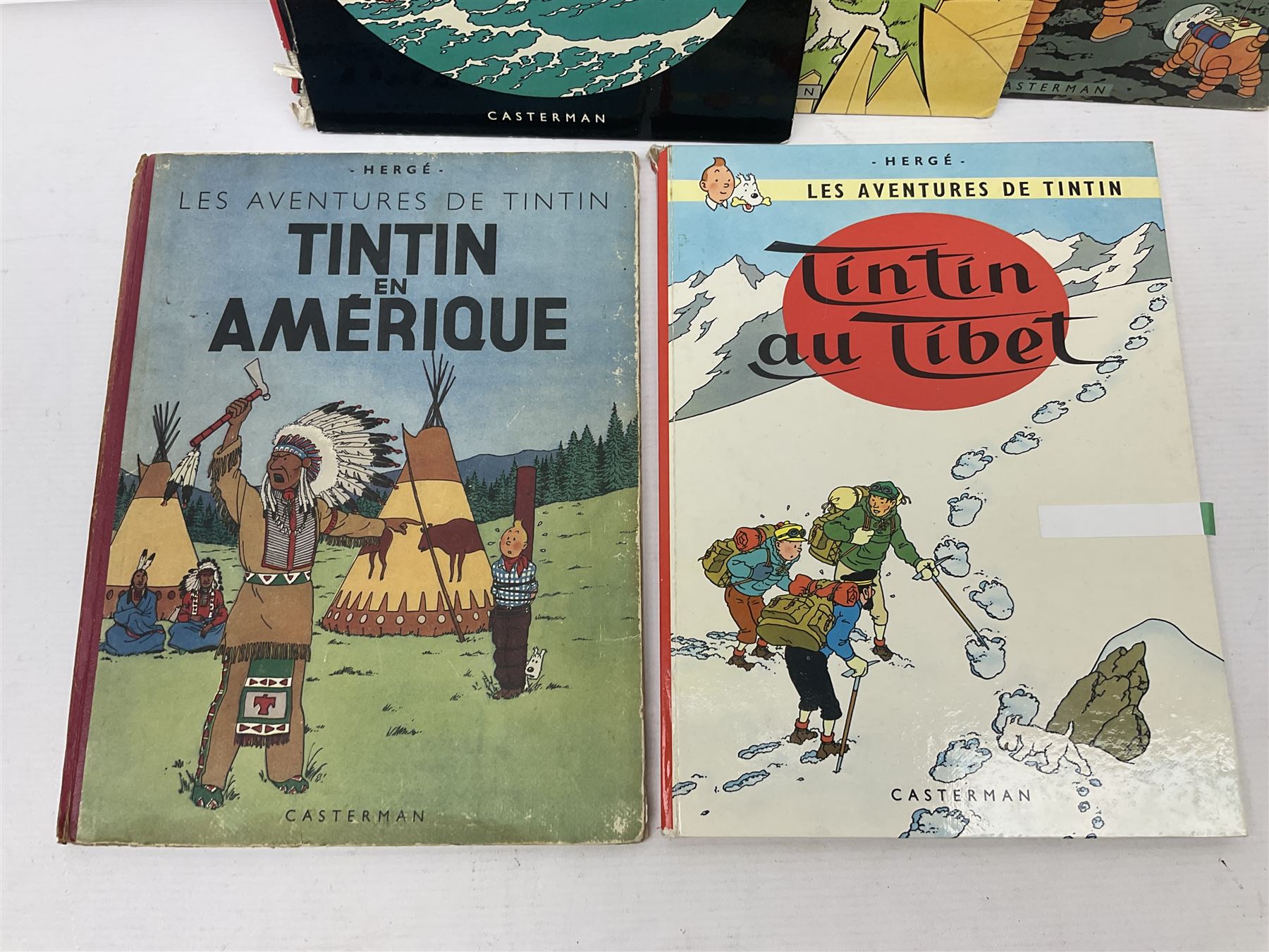 Twenty one first edition Herge, 'The Adventures of Tin Tin' books published by Casterman Bruxelles, with French text and coloured comic strip illustrations throughout; comprising Tintin Au Congo 1946, Tintin En Amerique 1946, Les Cigares du Pharaon 1955, Le Lotus Bleu 1946, L'Oreille Cassee 1943, L'ile Noire 1943, Le Sceptre d O'ttokar 1947, Le Crabe Aux Pinces D'or 1943, L'Etoile Mysterieuse 1942, Le Secret de la Licorne 1943, Le Tresors de Rackan Le Rouge 1945, Les 7 Boules de Cristal 1948, Le Temple du Soleil 1949, Au Pays de L'Or Noir 1950, Objectif Lune 1953, On a Marche sur la Lune 1954, L'Affaire Tournesol 1956, Coke en Stock 1958, Tintin au Tibet 1960, Les Bijous de la Castafiore 1963 and Vol 714 Pour Sydney 1968
