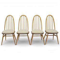 Ercol - elm dining chairs, set of six including two armchairs, arched spindle backs over shaped elm seats with upholstered pads, tapering beech legs joined by stretchers