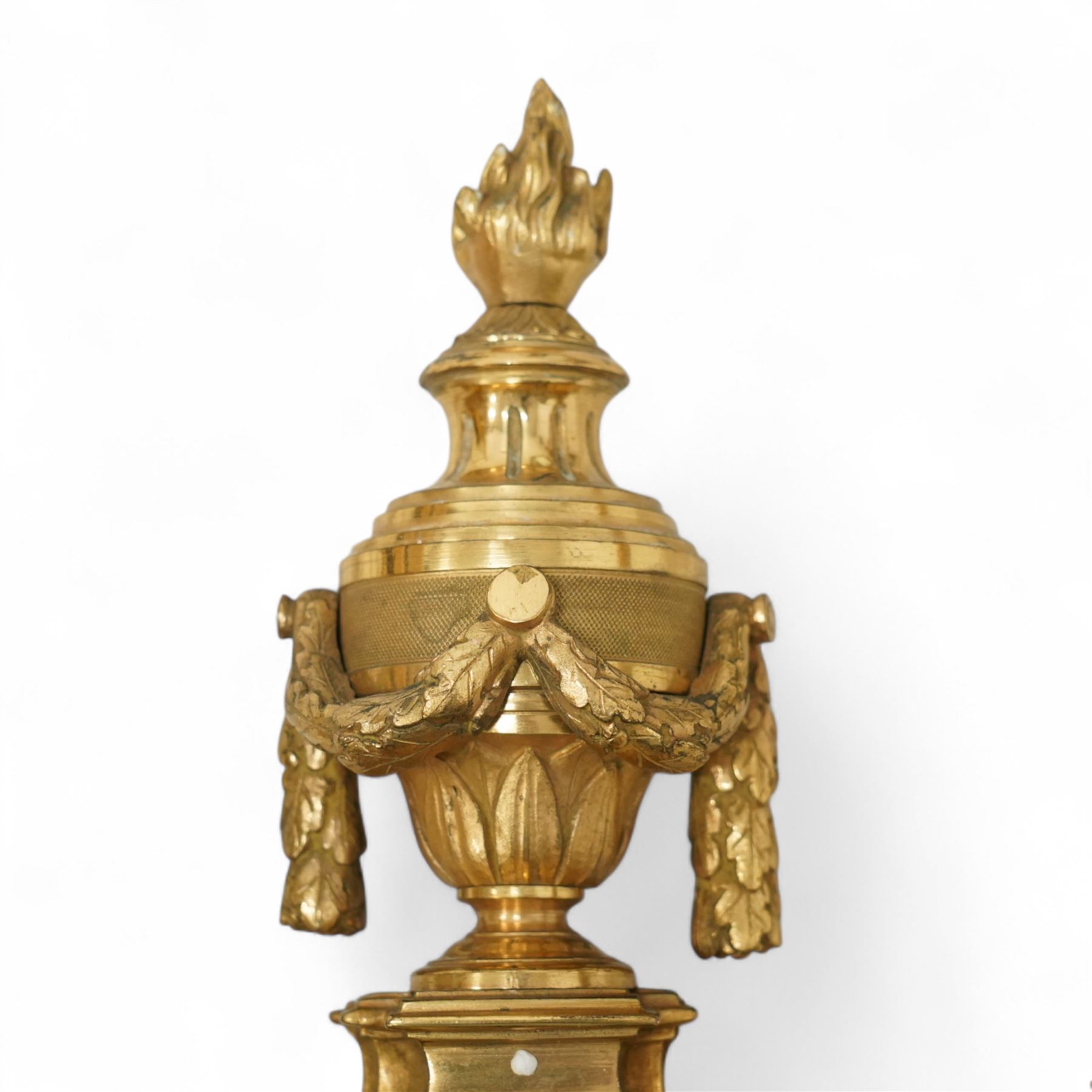 Pair of 19th-century Louis XVI-style ormolu rams-headed two-light wall appliques, the arms joined by a garland of laurel leaves, the half fluted stem surmounted by a vase with laurel garland, wired for electricity 