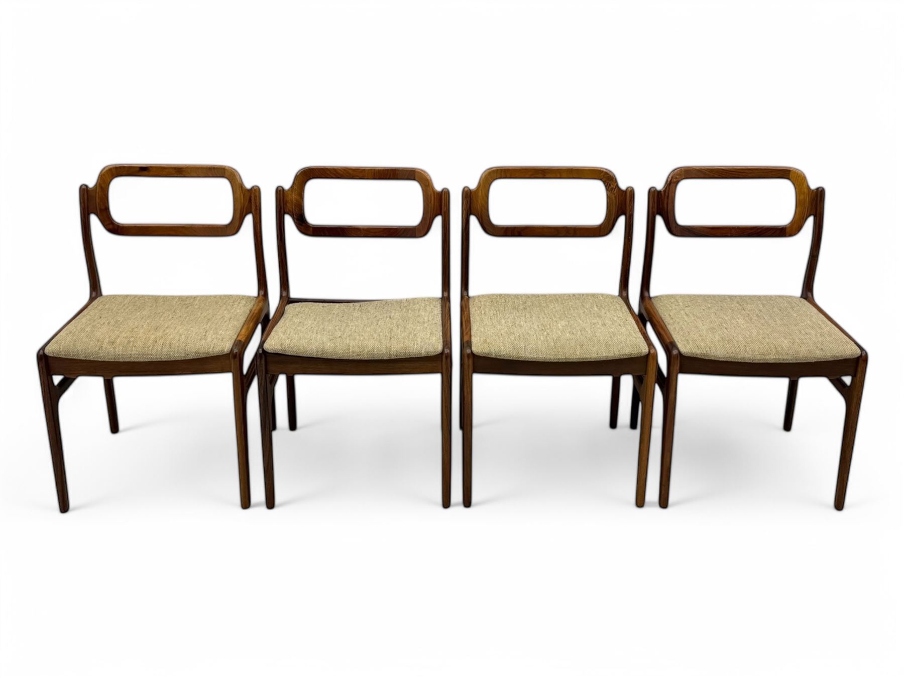 Johannes Andersen for Uldum Mobelfabrik - set of eight Danish teak dining chairs, each with open back rests with curved edges, upholstered seats in a neutral woven fabric, raised on tapered supports