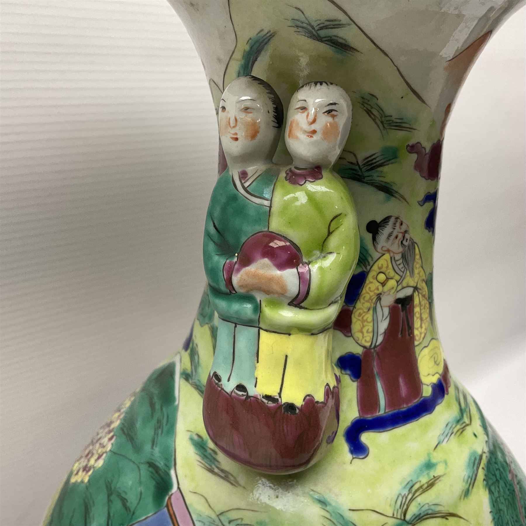 20th century Chinese Famille Rose vase, of baluster form with flared lobed rim and twin figural handles, decorated in polychrome enamel with figures dancing and playing instruments within a garden setting, H42cm