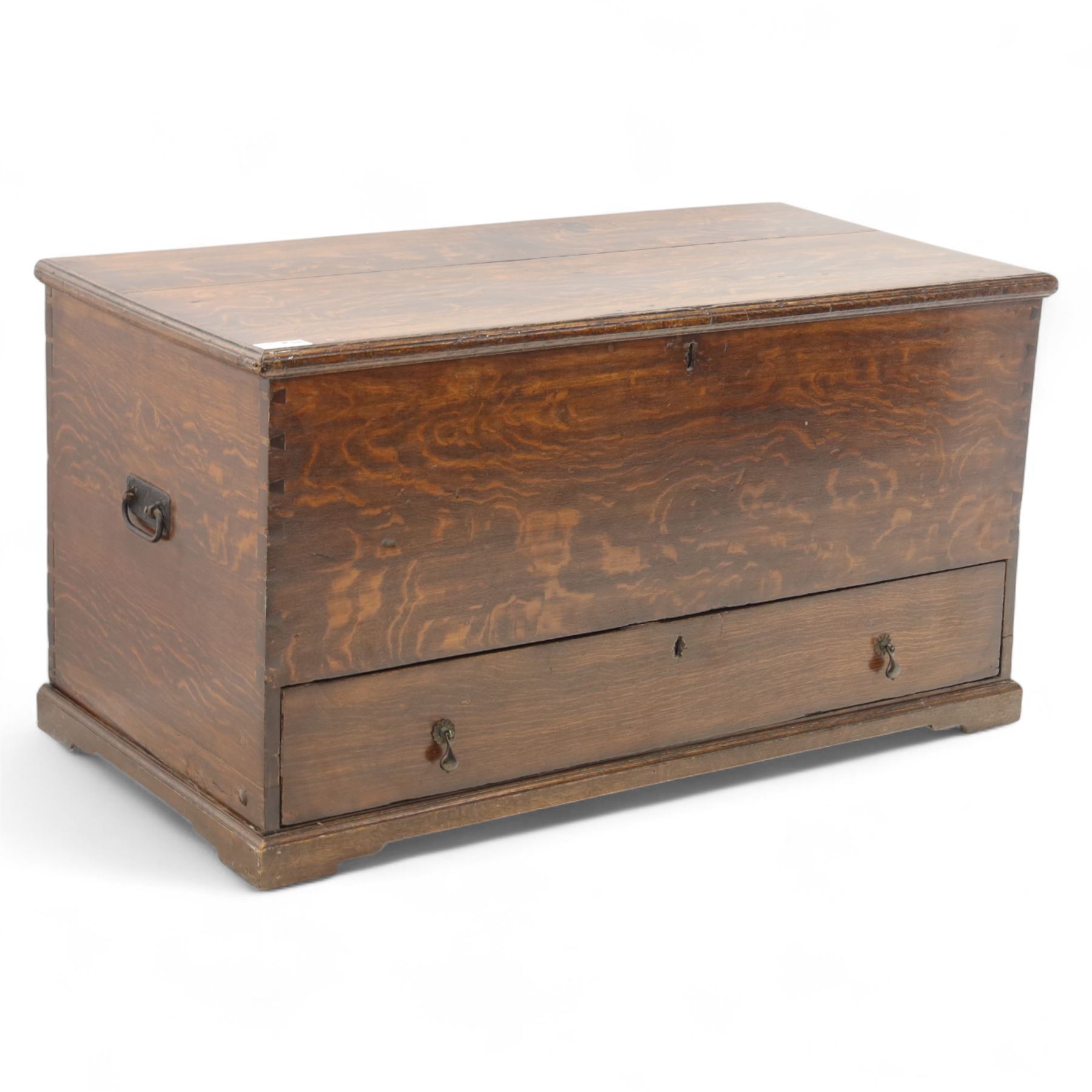 19th century oak blanket chest, rectangular hinged plank top with moulded edge, plain sides fitted with iron carrying handles, single full-width drawer to base with brass drop handles, on moulded plinth base