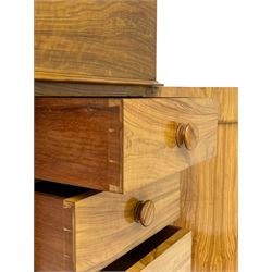 Fine and unusual 19th century olivewood piano top davenport, raised shaped back carved with olive branches and olives, the top hinges to reveal lidded and correspondence compartments, the piano lid enclosing sliding top with hinged and adjustable writing surface with leather inset, right-hand panelled door enclosing four drawers, olive branch and scroll carved cabriole front supports on moulded and shaped platform, turned cup feet with recessed castors 