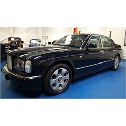 2001 Bentley Arnage Red Label Saloon

Registration: BU51 TGX
Engine: 6.75-litre turbocharged V8 petrol
Transmission: Automatic
Odometer reading: 39,942 miles
Colour: Black Sapphire metallic
Interior: Magnolia leather with burr walnut veneers
Previous owners: 3
V5C: Present
Service history: Good service records

An exceptional Bentley Arnage Red Label Saloon, finished in Black Sapphire metallic, a very dark blue, with a Magnolia leather interior, contrasting dark blue carpets and extensive burr walnut veneers. The car displays an odometer reading of approximately 39,942 miles.

The Arnage Red Label combined Bentley’s renowned 6.75-litre turbocharged V8 engine with automatic transmission, delivering effortless performance in a traditionally appointed luxury saloon. The model is distinguished by its imposing proportions, characteristic Bentley radiator grille and finely crafted interior.

Presented in excellent condition throughout, the bodywork and metallic paint finish appear particularly well preserved, complemented by clean brightwork and the correct Bentley alloy wheels. The engine bay is also notably well detailed.

The interior presents exceptionally well, retaining its Magnolia leather upholstery, polished burr walnut veneers, original factory instrumentation and switchgear. The leather displays only light creasing consistent with careful use.

The car has had three previous owners and is accompanied by good service records.

Features

• 6.75-litre turbocharged V8 petrol engine
• Automatic transmission
• Black Sapphire metallic paintwork
• Magnolia leather interior
• Contrasting dark blue carpets
• Burr walnut veneers
• Electrically adjustable front seats
• Air conditioning
• Factory instrumentation and switchgear
• Bentley alloy wheels
• Right-hand drive
• Odometer reading of approximately 39,942 miles
• Three previous owners
• Good service records
• V5C present

This vehicle forms part of the Estate of the Late John Sills and is offered for sale by the Executors, confirming a genuine reason for sale.