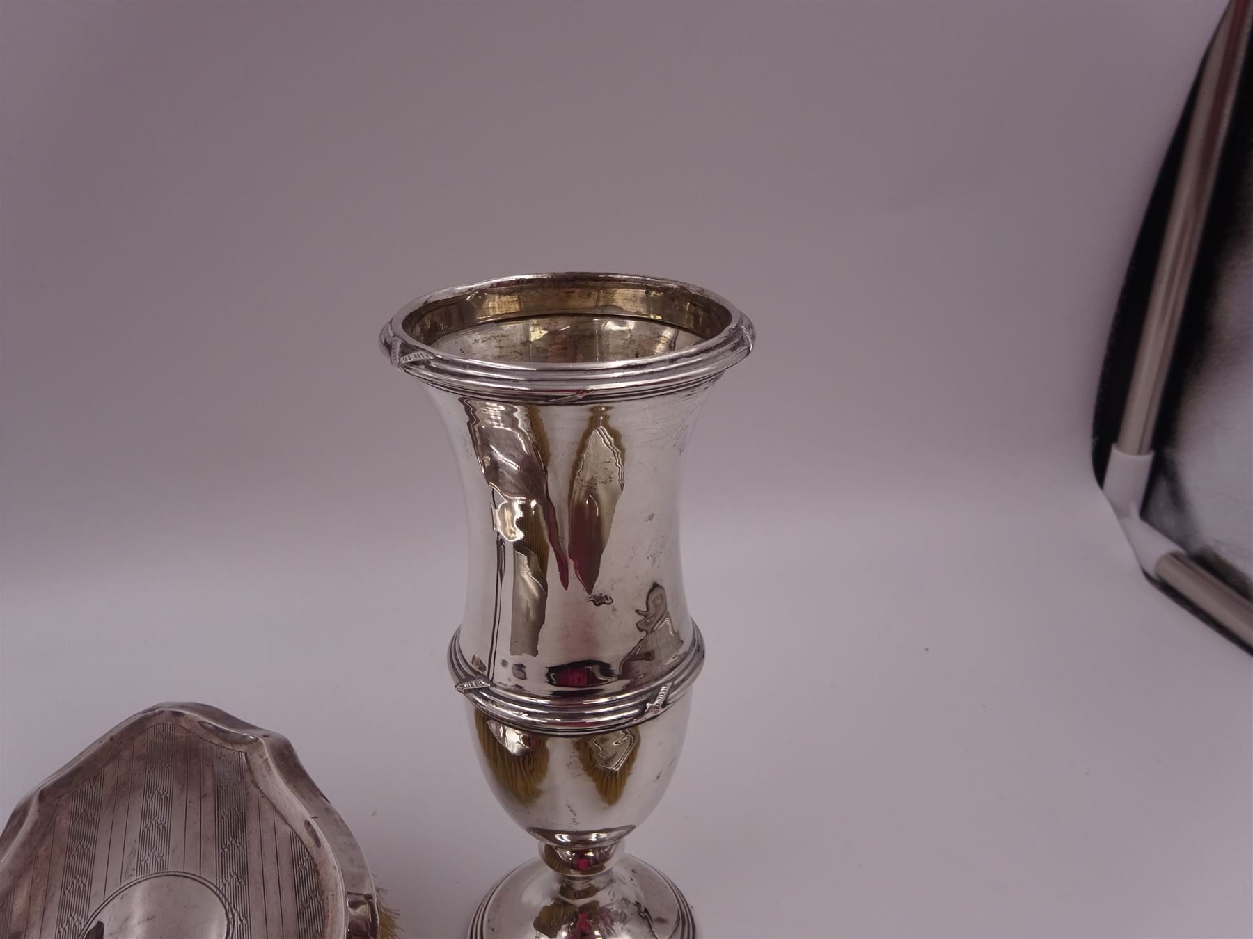 Early 20th century silver vase, of waisted form, with reed and bow border, upon knopped stem and filled circular stepped foot, hallmarked William Comyns & Sons, London 1911, H15cm, together with pair of Indian silver trumpet vases, with chased and embossed floral decoration, a pair of silver mounted clothes brushes, hallmarked Deakin & Francis Ltd, Birmingham 1946  and a 1920s silver mounted hairbrush, hallmarked W J Myatt & Co, Birmingham 1922