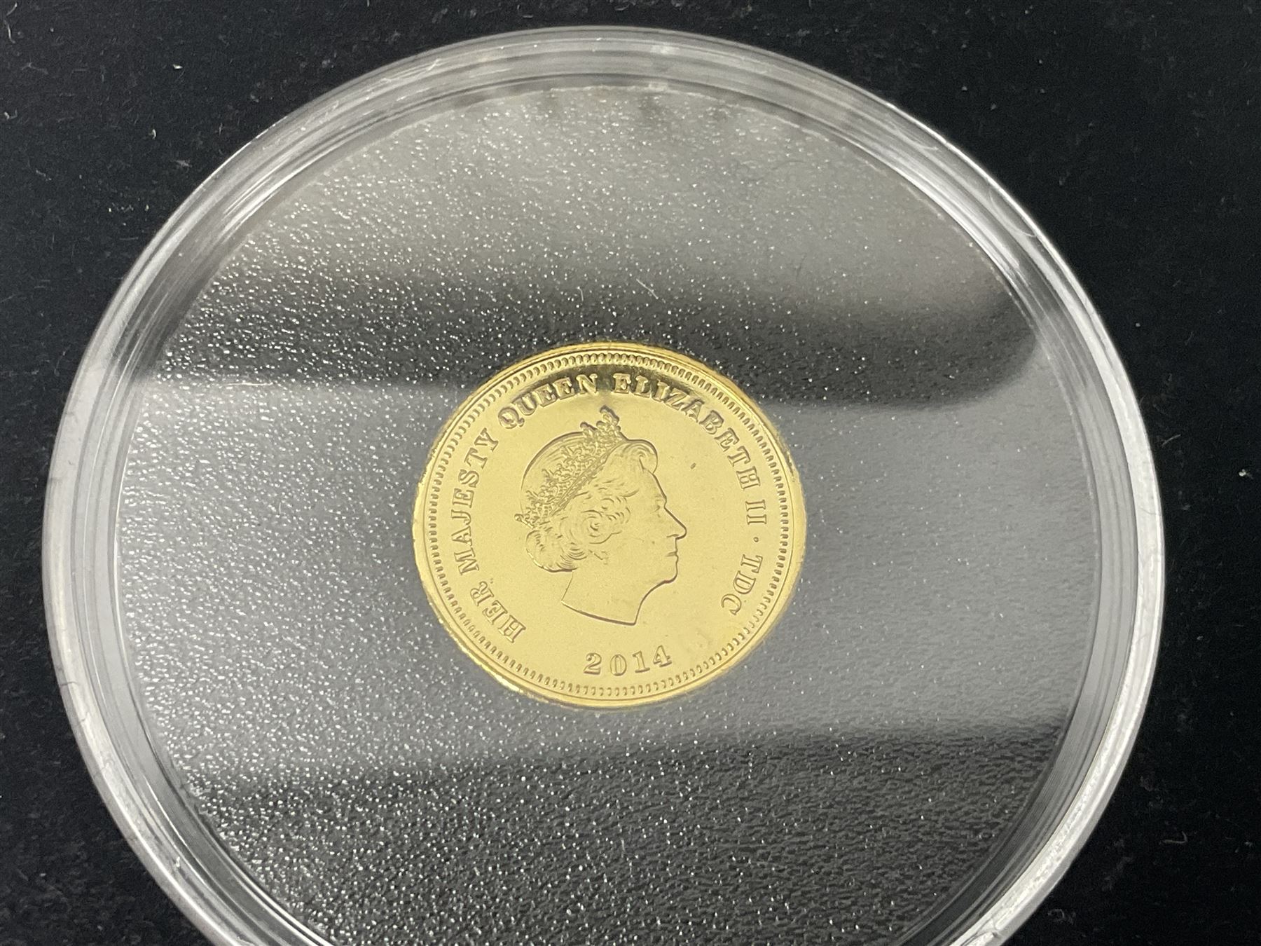 Queen Elizabeth II 2000 'The Queen Mother' silver proof five pound coin, 2000 'Millennium' silver proof five pounds, 2007 'Scouts' silver proof fifty pence, Tristan Da Cunha 2014 9ct gold 1 gram gold one crown coin, all cased with certificates and a 'Prince Charles 60th Birthday Commemorative Coin Cover' containing a 2008 silver proof five pound coin in folder (5)