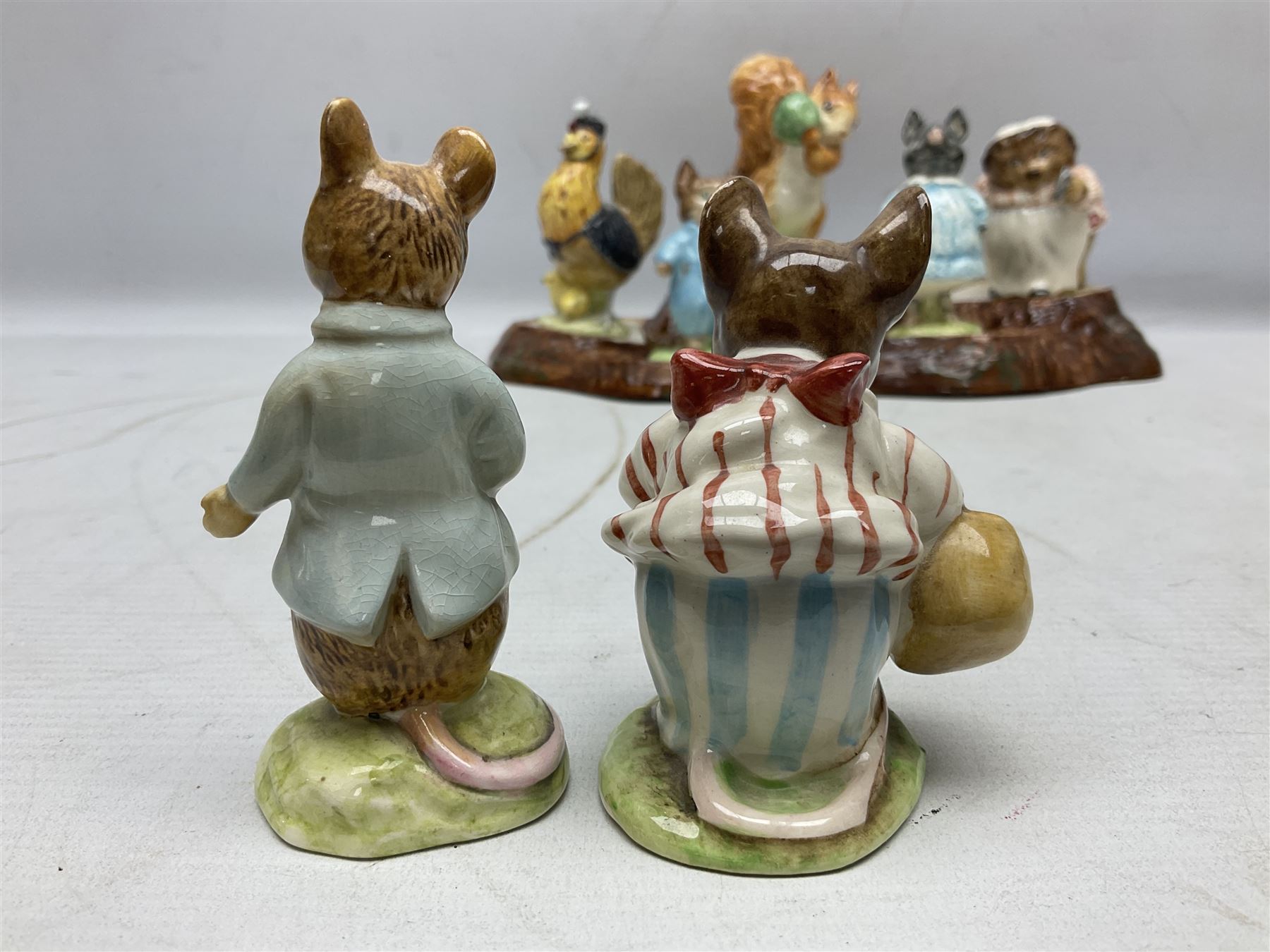 Seven Beswick Beatrix Potter figures, comprising Sally Henny Penny, Johnny Town-Mouse, Mrs Tiggy-Winkle, Mrs Tittlemouse, Tom Kitten, Pig-Wig and Squirrel Nutkin, together with a Beswick tree trunk display stand, stand L30cm