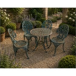 Cast iron garden table and four chairs, in the Art Nouveau style, with pierced floral and ...