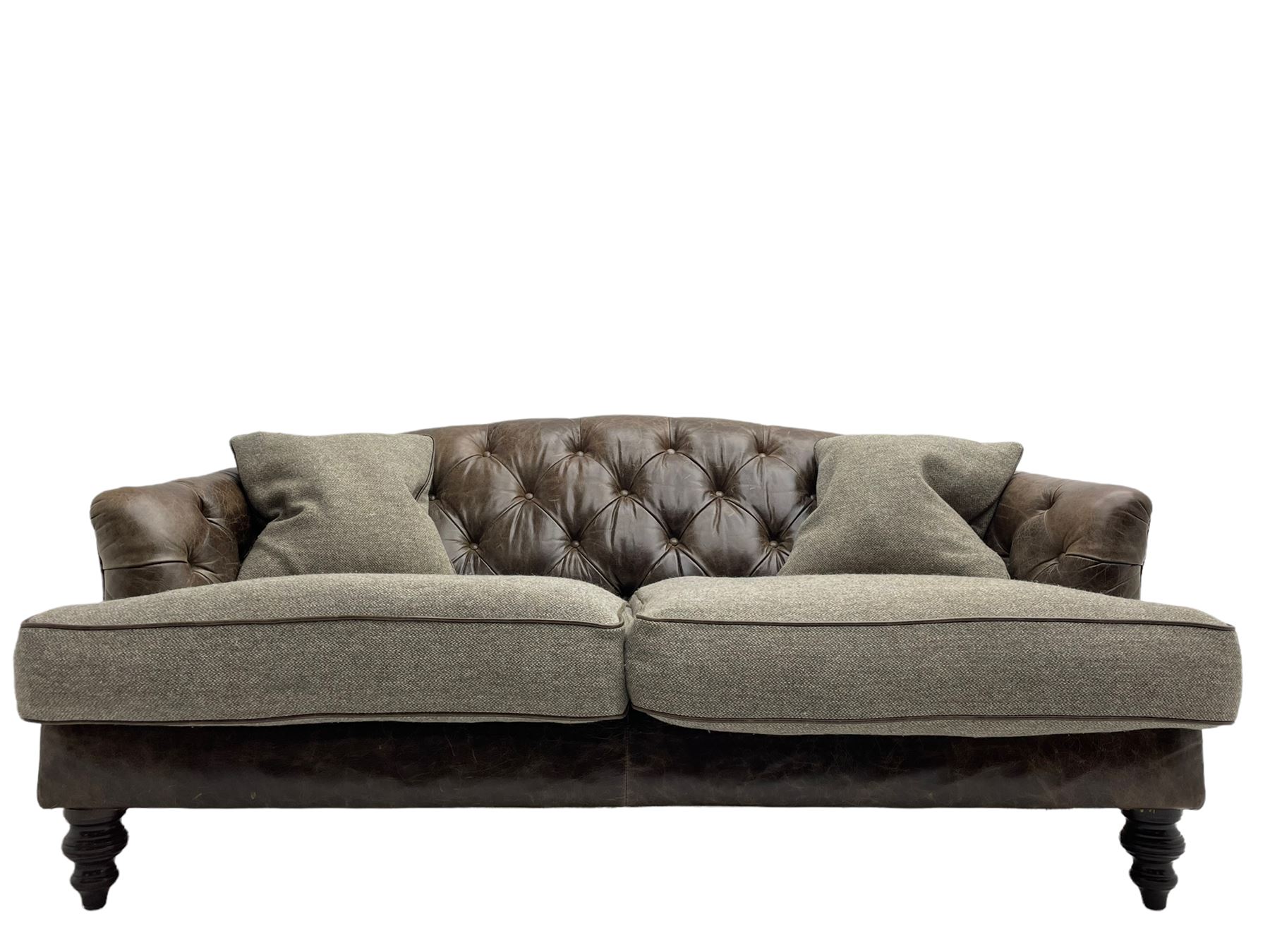 Tetrad - 'Dalmore' traditional shaped two seat sofa, upholstered in buttoned brown leather with contrasting wool seat cushions, together with scatter cushions, on turned front feet