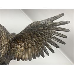 Bronze eagle, modelled in a standing position with wings spread, raised on a black veined marble circular plinth base, H29cm
