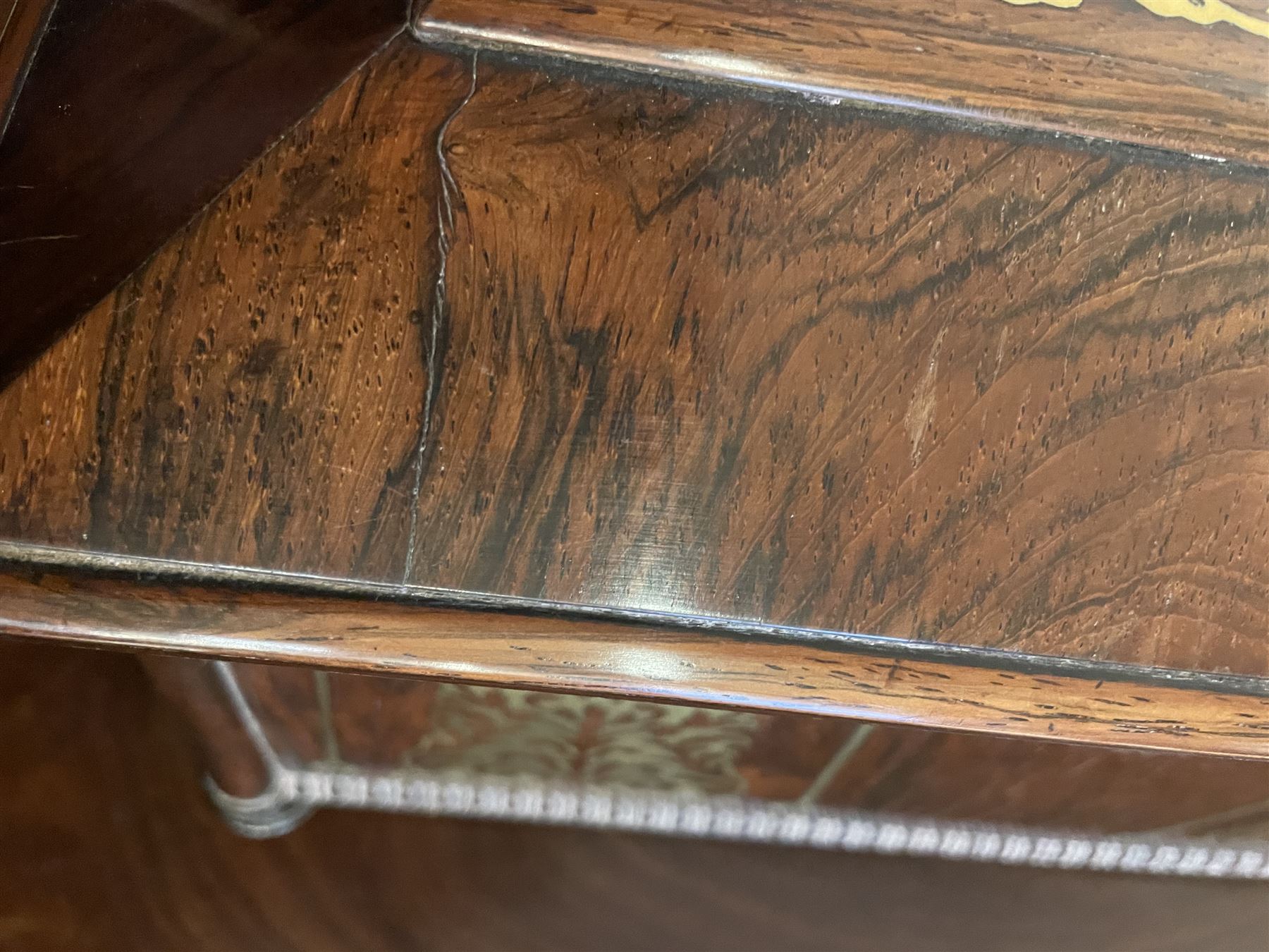 Early 19th century rosewood and brass inlaid tea caddy, of sarcophagus form, the front and hinged opening cover inlaid with brass scrolling panels, opening to reveal a compartmented interior with twin removable boxes with conforming inlaid brass detail to the hinged covers and zinc lining to the interiors, flanking a later glass mixing bowl, the whole upon four turned cylindrical feet, H21cm W36cm D20cm