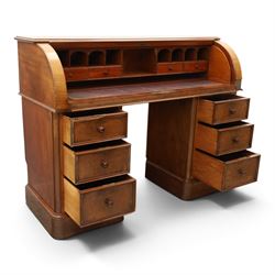 Victorian mahogany twin pedestal cylinder desk, with roll top with fitted interior and with leather writing slide, raised on pedestals with three graduating drawers, raised on a plinth base with castors