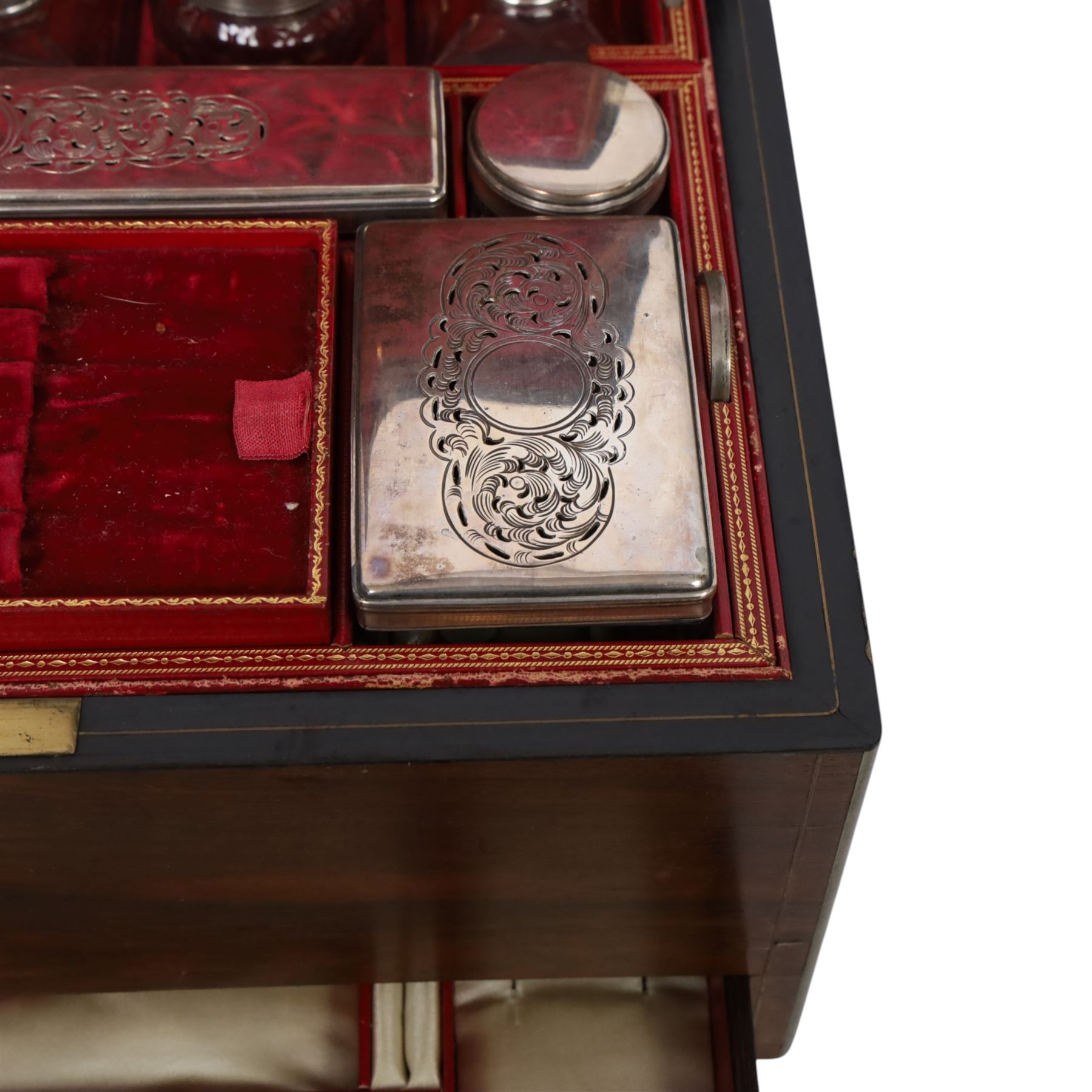  Victorian brass inlaid rosewood dressing table box, retailed by F.L. Hausburg, Liverpool, the lid centred by a brass cartouche, opening to reveal letter store to lid underside, above a fitted interior, with ten mounted cut glass jars, bottles and manicure set, within lift out leather trays, above jewellery drawer, with key, H17cm D24cm