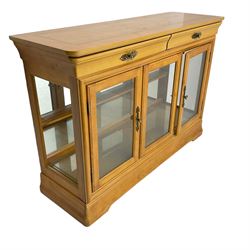 Yew wood sideboard, rectangular top with mahogany and ebony stringing, fitted with two drawers over three glazed cupboard doors enclosing glass shelves