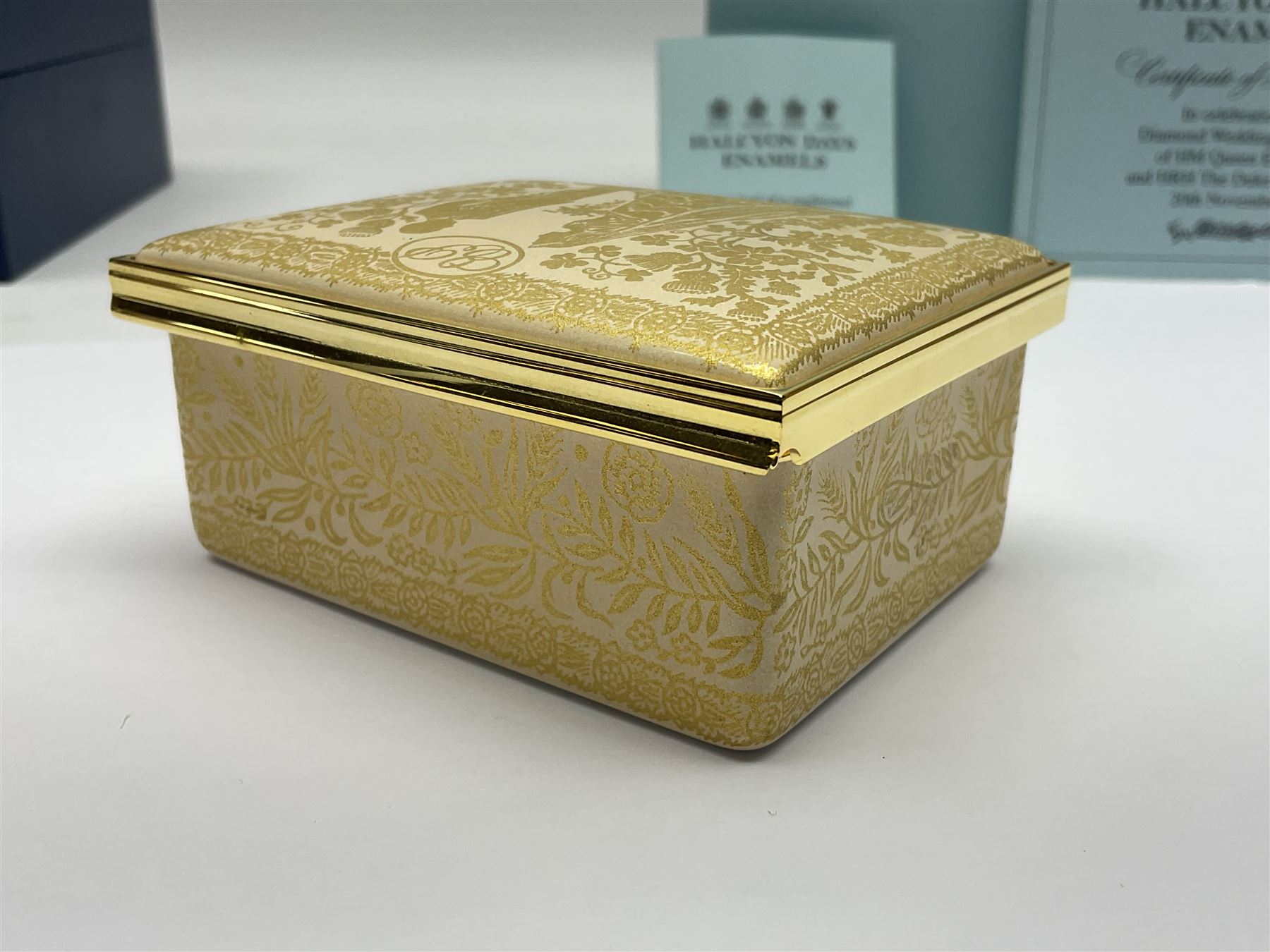 Two Halcyon Days enamel boxes, both of rectangular form, the first depicting Buckingham Palace, 'To Celebrate the Golden Jubilee of Her Majesty Queen Elizabeth', the second depicting the marriage of The Queen and Prince Philip, in celebration of their Diamond Wedding Anniversary, H4cm, W8.5cm, both boxed