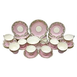 Late 19th/early 20th century Delphine Crown China tea service for twelve decorated with floral and gilt repeated patterned borders on pink ground
