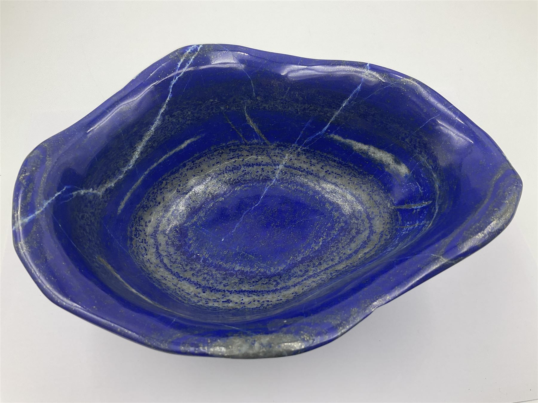 Carved bowl, flat-bottomed bowl carved from a single piece of Lapis lazuli with flared rim, H8cm, L21cm