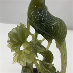 Carved jade figure of a phoenix perched on a flowering branch, upon a wooden stand, with original box, H27cm