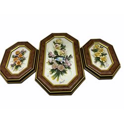 Set of three Capodimonte wall plaques, depicting floral decoration in octagonal frames with gilt edging, largest plaque H48, two small plaques H31cm.    