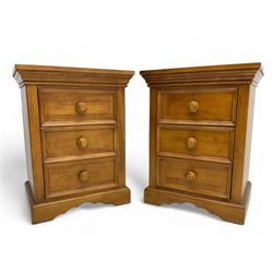 Pair of contemporary cherry wood bedside chests, rectangular top and projecting moulded cornice over three drawers, on plinth base with shaped apron