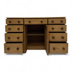 Late 19th-century Victorian stripped pine twin pedestal kneehole dressing table, the rectangular top above three short and three graduated drawers on each pedestal and a central cupboard, on a moulded plinth base 