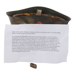 Italian RSI/10th M.A.S. Flotilla (Decima Flottiglia MAS). M33 Camouflage helmet- re-issued to the G.N.R. Circa.1944/45
extremely rare Italian M33 steel helmet in camouflage paintwork which belongd to the famous 'Decima Flottiglia MAS' the Italian Elite Naval Commandos. The helmet retains the Italian tri-colour to oneside, the yellow anchor to the front and the red X to the other side. the helmet is complete with its correct liner and chinstrap. When it was re-isseued it was painted in camouflage with the new insignia to the front of the G.N.R. 'Guardia Nazionale Republican' and this camouflage was only used to the latter part of WWII by R.S.I (Repubblica Sociale Italiana)   