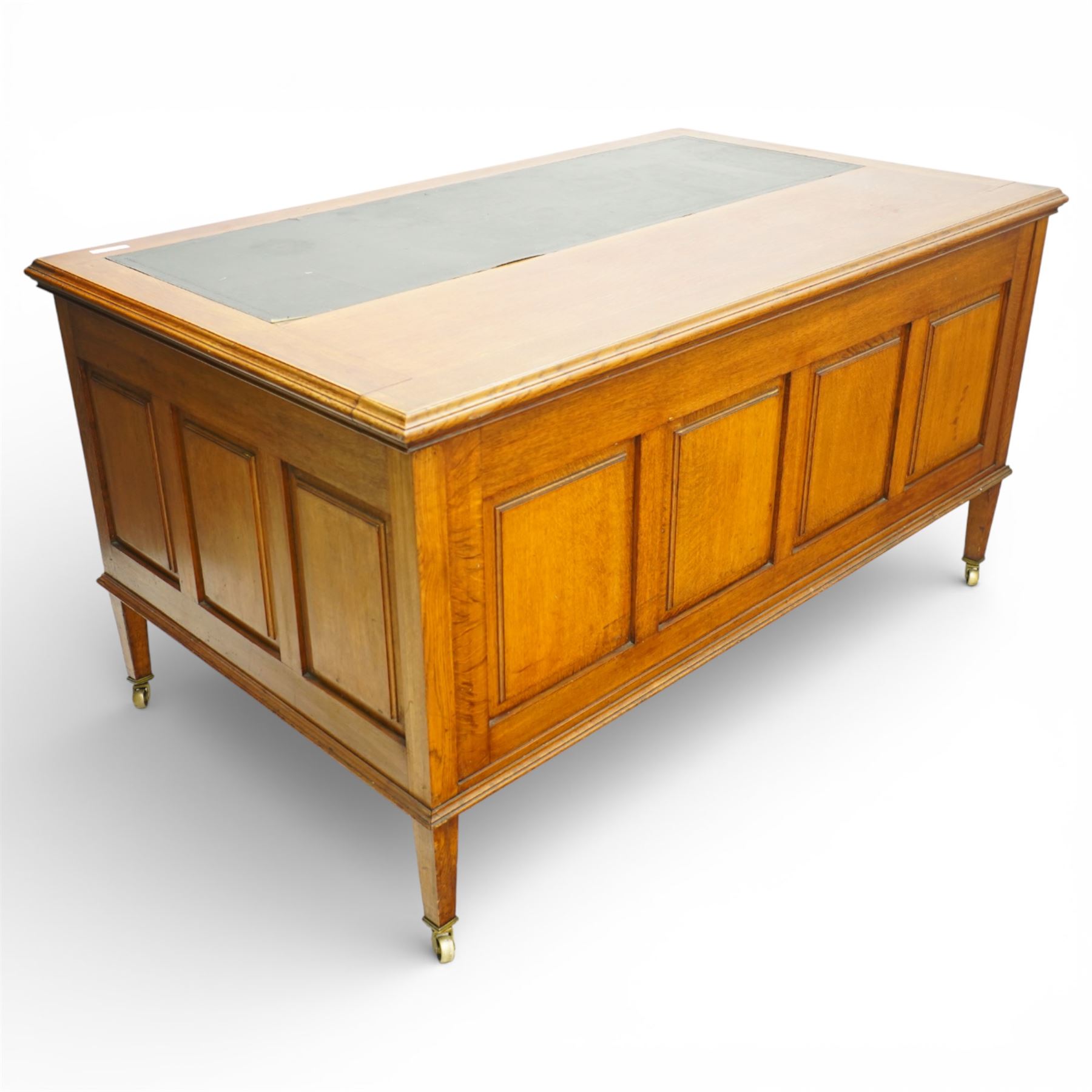20th century oak kneehole desk, rectangular black leather inset top, above a single frieze drawer, flanked by two pedestals with slides and drawers, panelled sides and back 