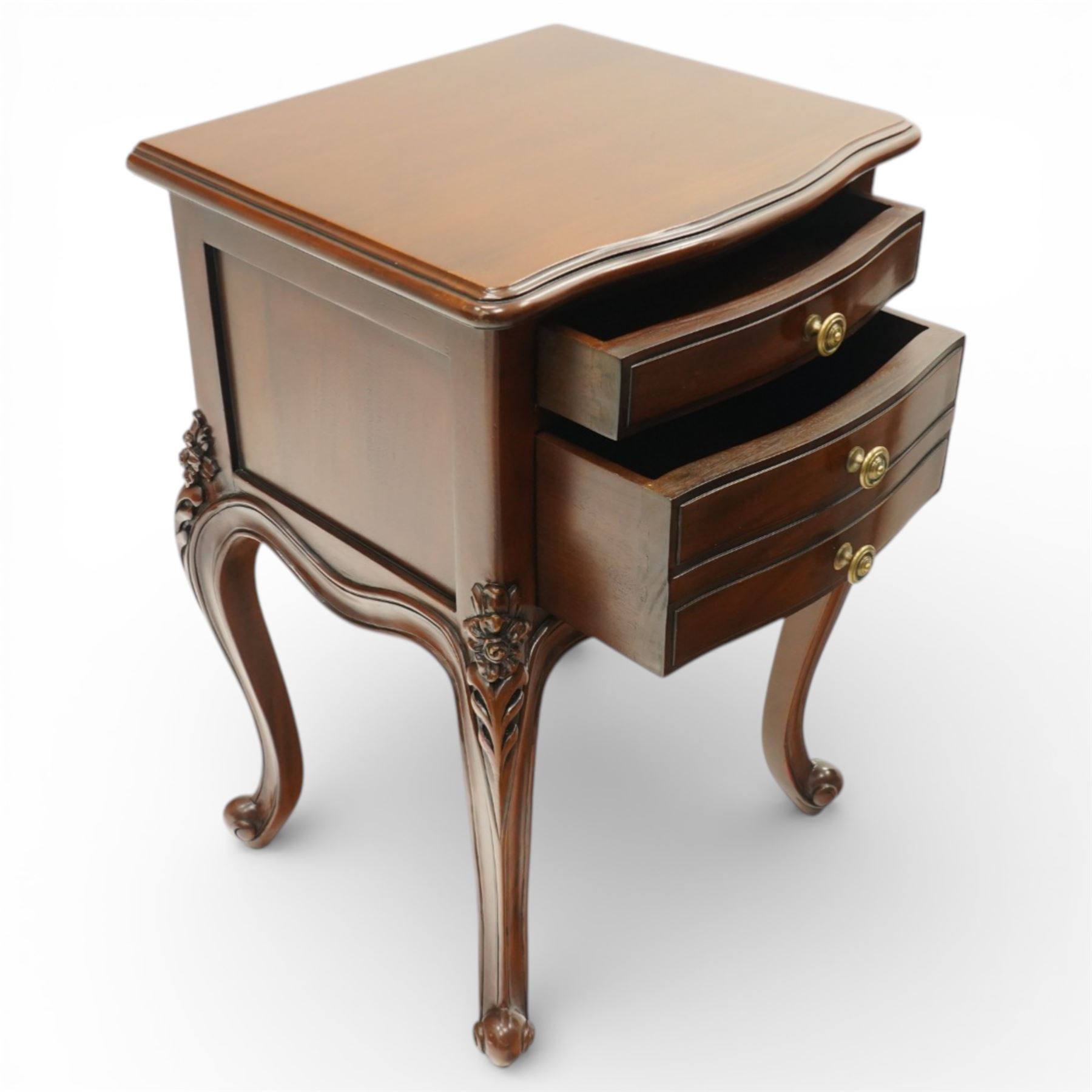 Pair of French Rococo design bedside chests, with serpentine fronts, two drawers, brass handles and carved floral decoration, raised on cabriole legs with scroll feet