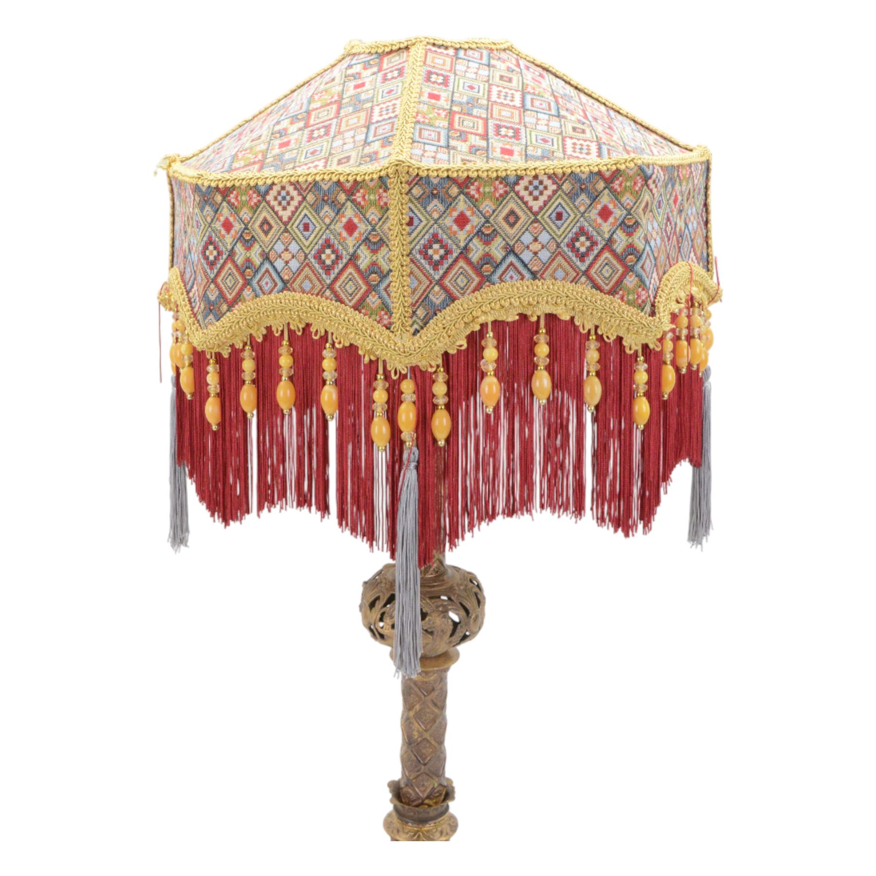 Gilt table lamp, three lion paw feet on a triangular base with column central support decorated with floral motifs, with octagonal shade, H85cm 