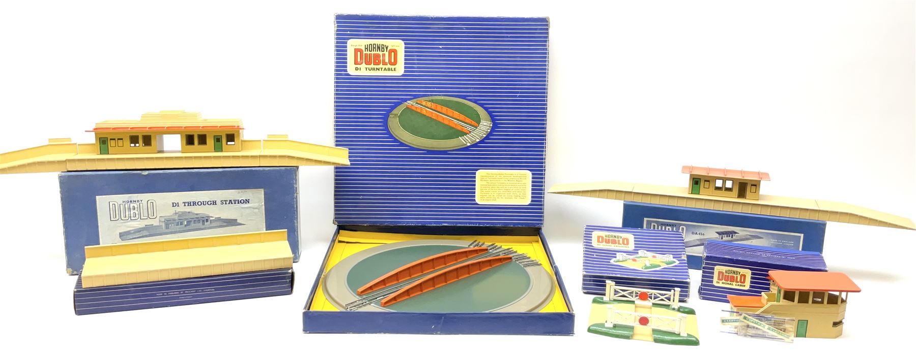 Hornby Dublo - six D1 accessories comprising Turntable; Through Station with separately boxed Platform Extension with Wall; Signal Cabin with orange roof and two packs of station names; Level Crossing; and Island Platform; all boxed (6)