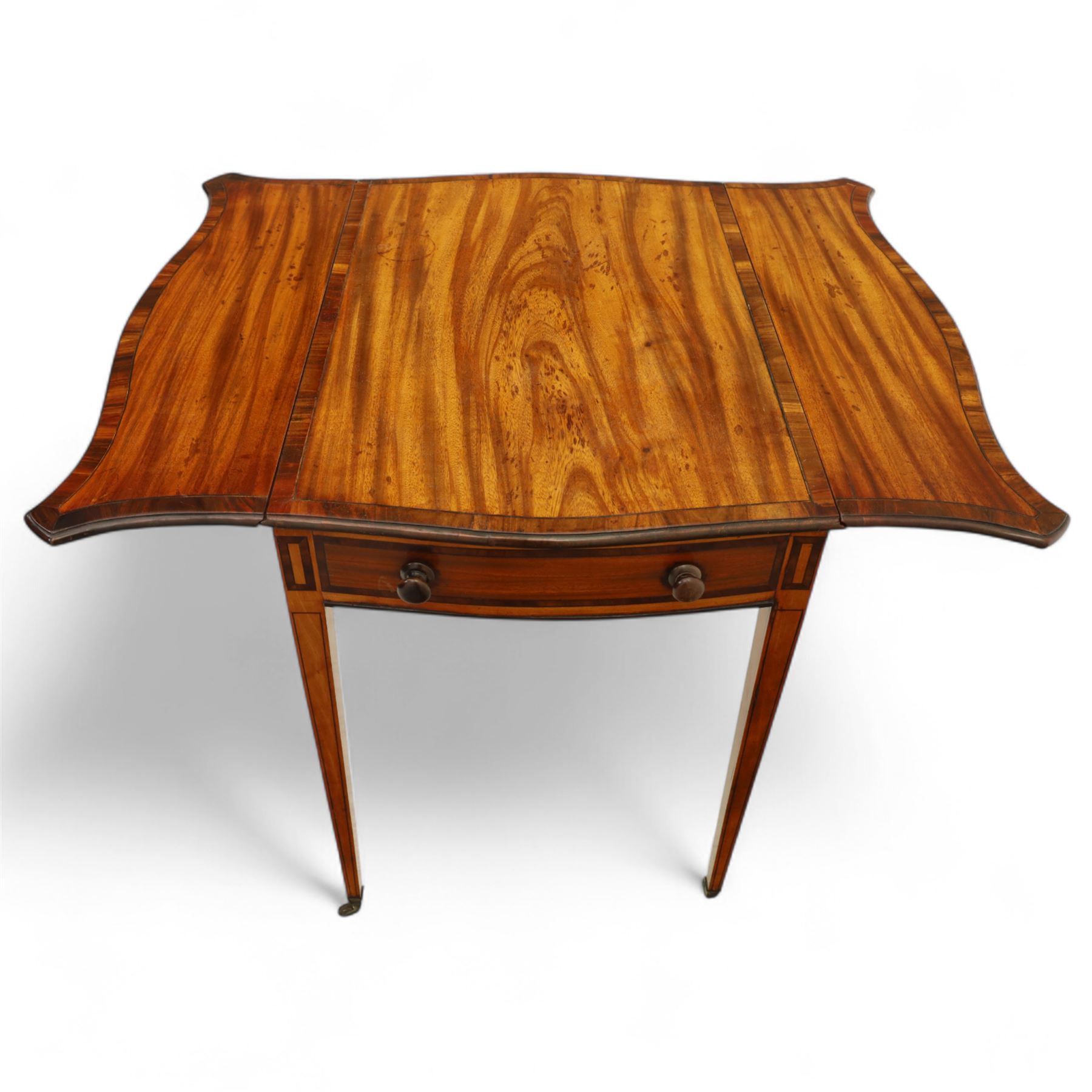 Goergian small butterfly pembroke table, the rectangular top with crossbanded edge and rounded drop leaves, single frieze drawer with opposing dummy drawer, raised on square tapering legs with stringing, terminating in brass castors