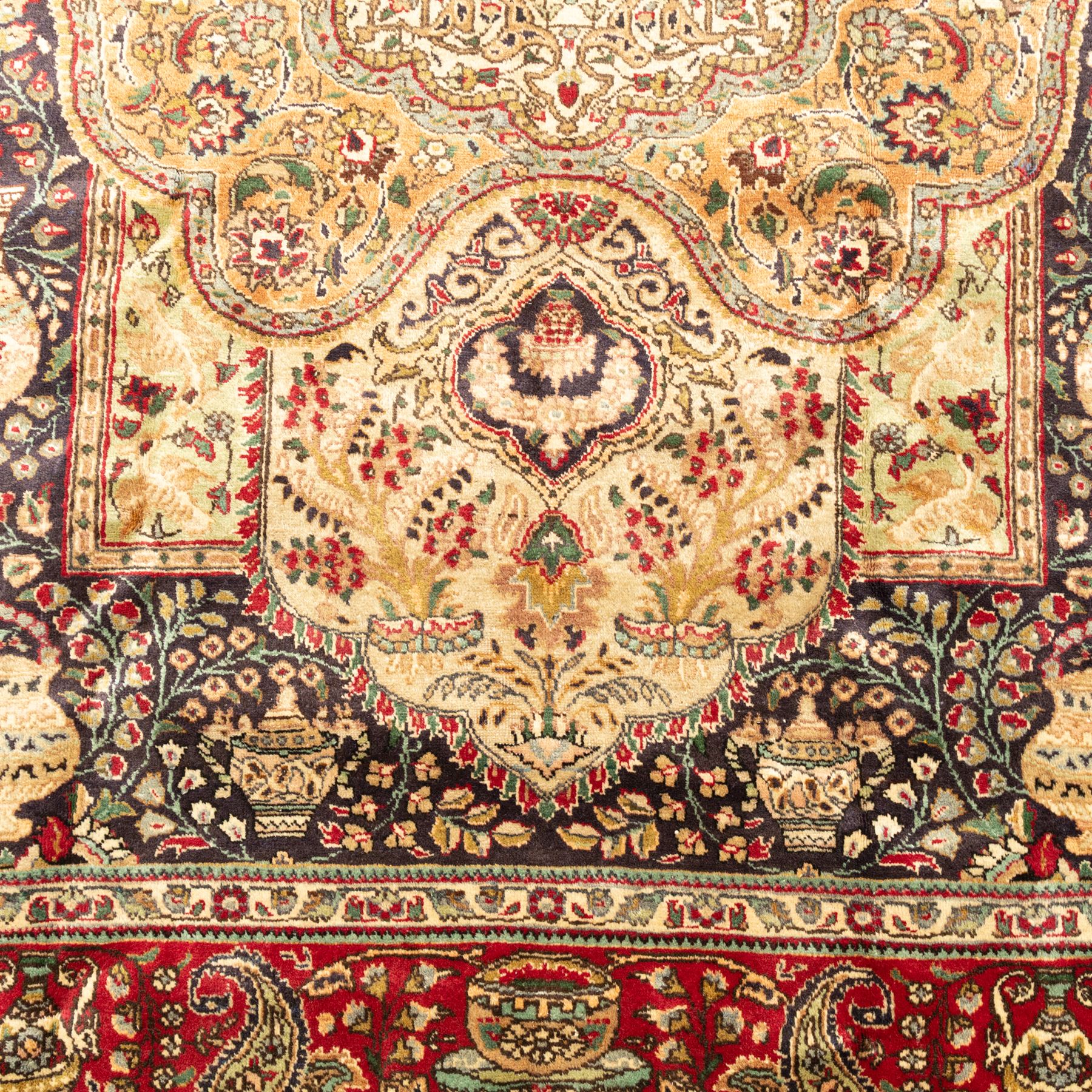Azerbaijan rug, intricate central medallion in muted golds and greens surrounded by navy panels filled with boteh and floral designs, enclosed by a red main border featuring stylised boteh motifs, woven in the Caucasus region of Azerbaijan