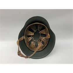 Fully restored German steel helmet, the camouflage painted exterior with two decals and replacement leather liner