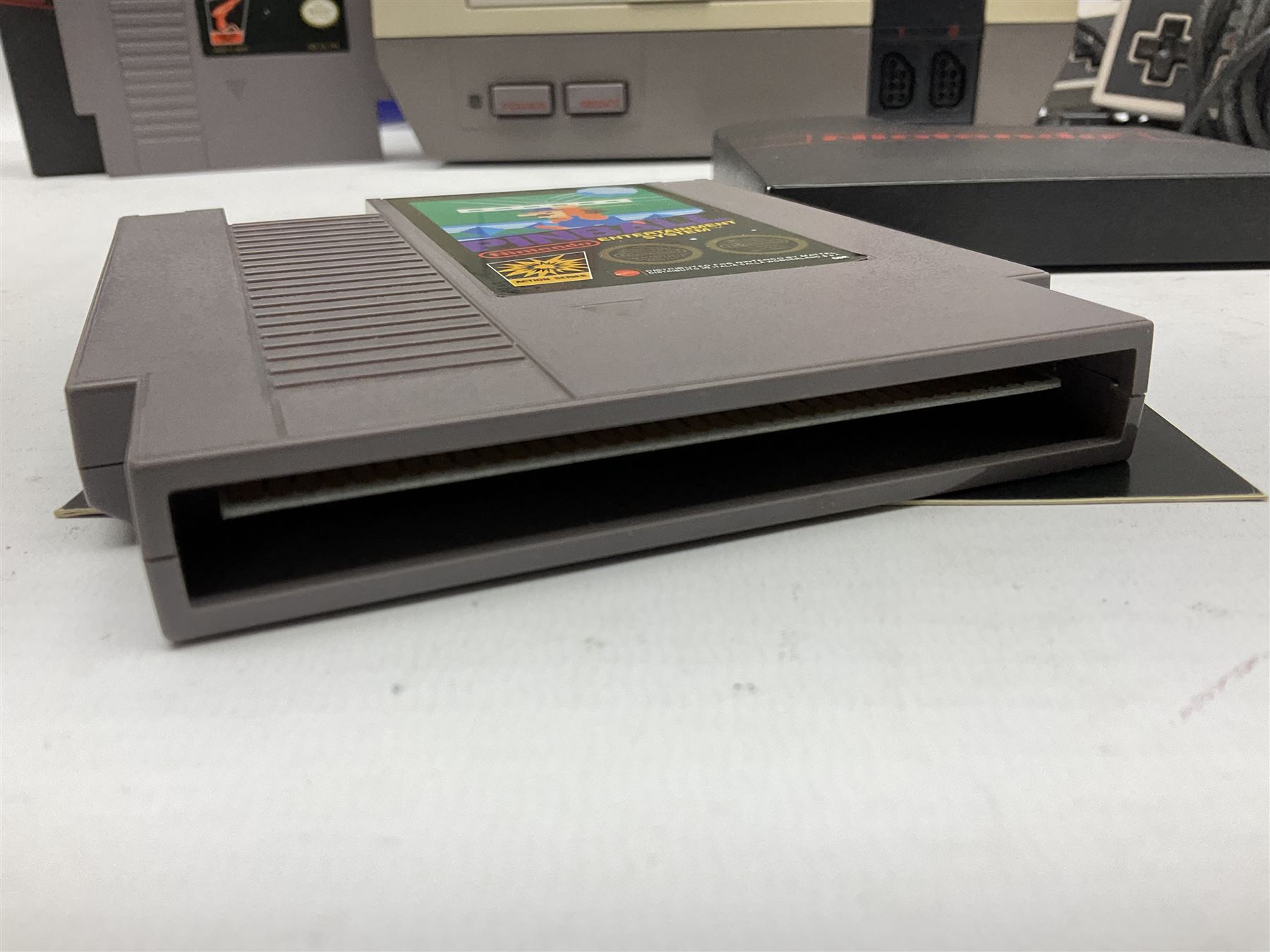 Nintendo Entertainment System (1985) console with two controllers, accessories and instruction booklet. NES Games ‘Duck Hunt’ with Nintendo Zapper gun, ‘Pinball’ and ‘Super Mario Bros.’, all with original sleeves and instruction booklets. NES game ‘Super Mario Bros. 2’ cartridge only