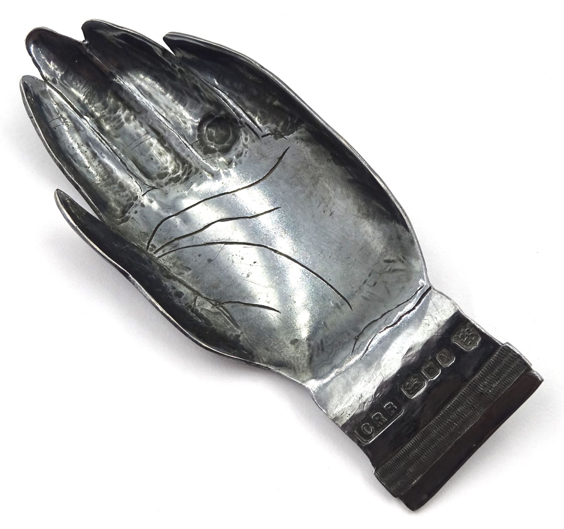 Modern Guild of Hull Silversmiths oxidised silver caddy spoon, modelled as an outstretched hand with engraved wristwatch to wrist and inset turquoise cabochon to finger, hallmarked Charles Richard Berkin of Beverley, London 1987, also marked with the three crowns mark of the Guild of Hull Silversmiths, L 8.7cm, approximate weight 0.89 ozt (27.9 grams)

Abraham Barachin was the last Hull silversmith to use the Hull mark of three ducal coronets in around 1706. 
However in 1983 the Assay Offices of Great Britain and the City of Kingston upon Hull granted the Guild of Hull Silversmiths permission to use the City's Coat of Arms as an additional mark on pieces they produced. 