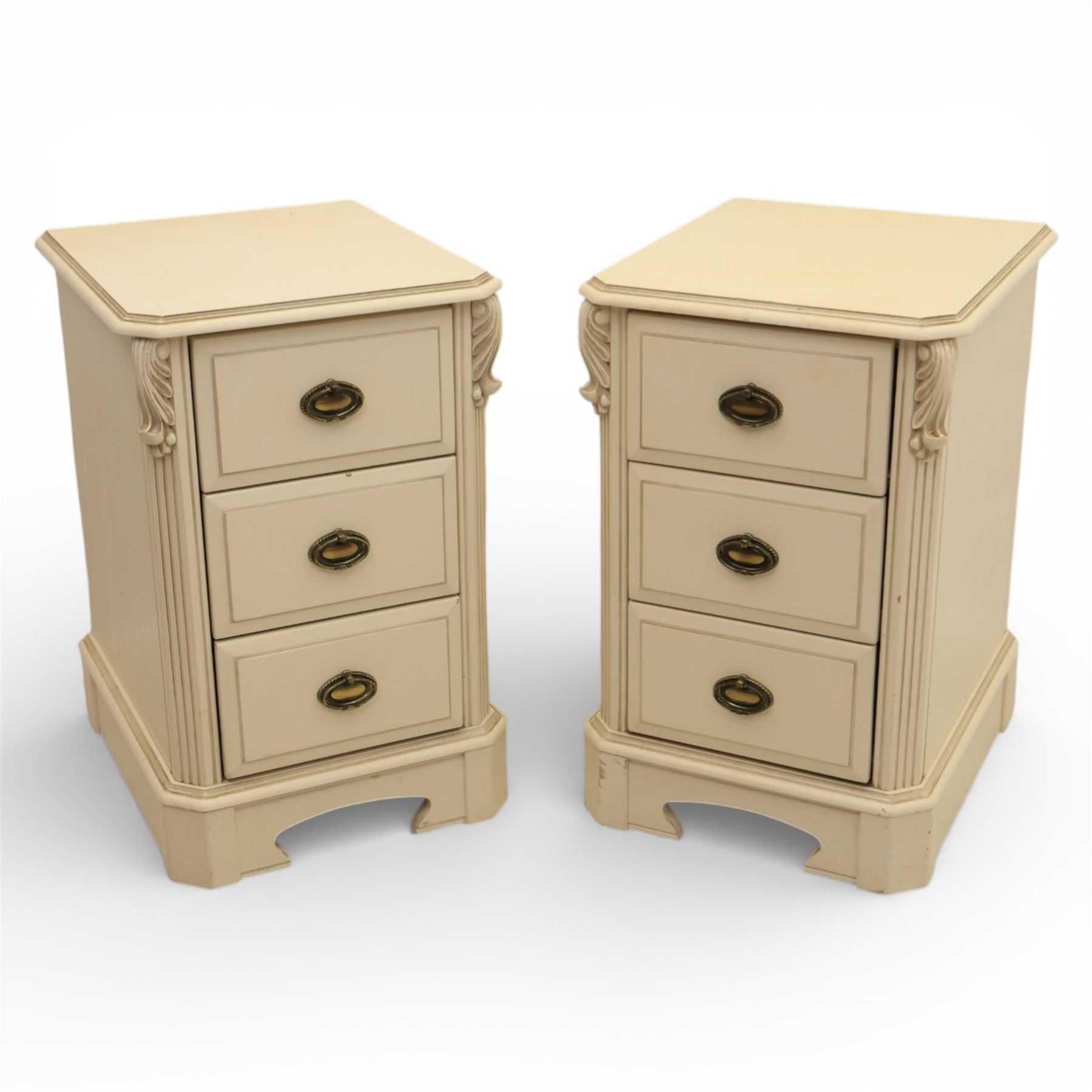 Contemporary French design white painted bedroom suite retailed by Barkers of Northallerton, comprising wide chest fitted with four short and four long drawers with oval brass handles (H 70cm, W 159cm, D 46cm), pair of bedside chests each fitted with three drawers (H 62cm, W 40cm, D 46cm), dressing table fitted with four short drawers and central kneehole with shaped apron (H 79cm, W 131cm, D 46cm) with matching framed wall mounted mirror (H 100cm, W 113cm), and full length standing mirror (H 175cm, W 73cm)