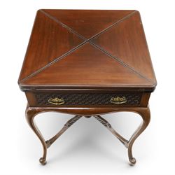 Edwardian carved mahogany envelope card table, the rectangular quadruple hinged top enclosing baize-lined interior, the single frieze drawer and sides with blind-fretwork carving, over cabriole supports with scroll feet and castors united by pierced lattice fretwork X-stretcher with turned finial